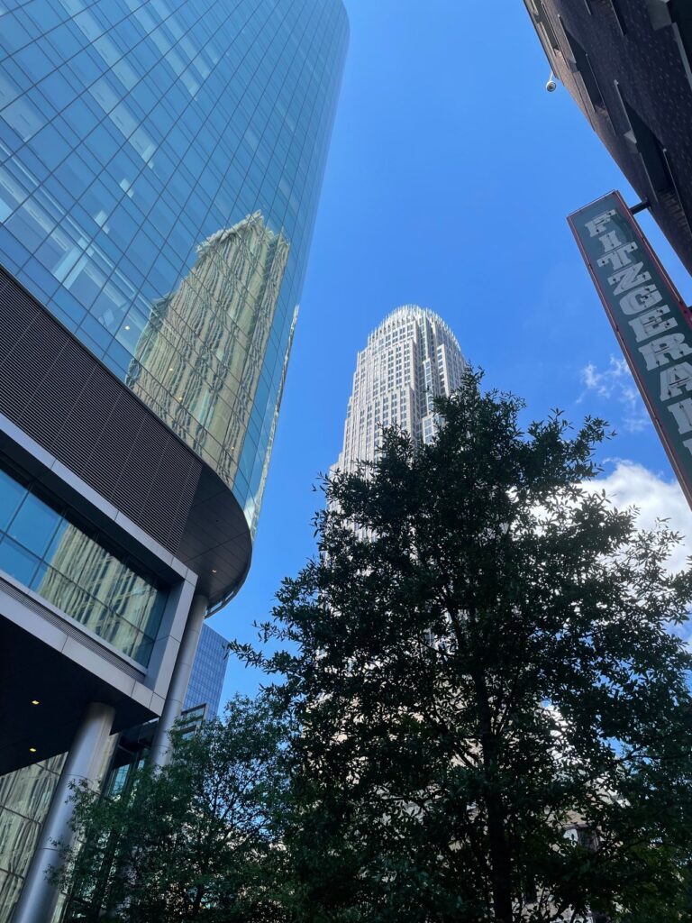 Captivating view of Charlotte, NC skyline featuring modern skyscrapers under a bright blue sky