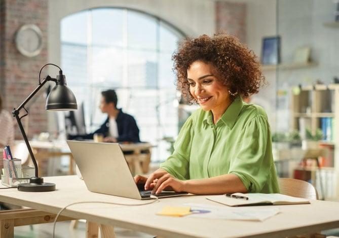 Small business owner working at a laptop to build an online presence